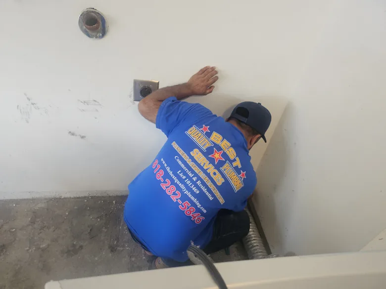 Technician working at an open wall connection