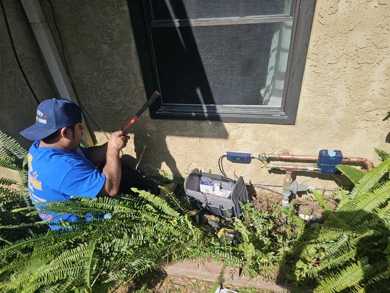 Technician opening an exterior wall below a window