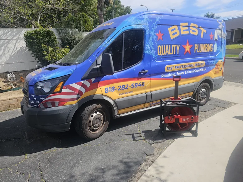 Branded van with drain machine outside