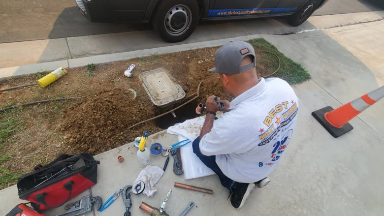 Technician with test equipment at exterior water access