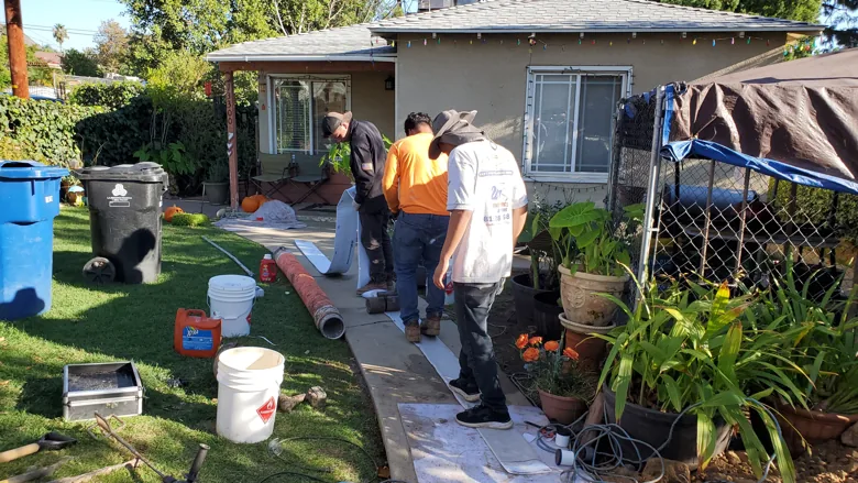 Crew and equipment at residential pipe project
