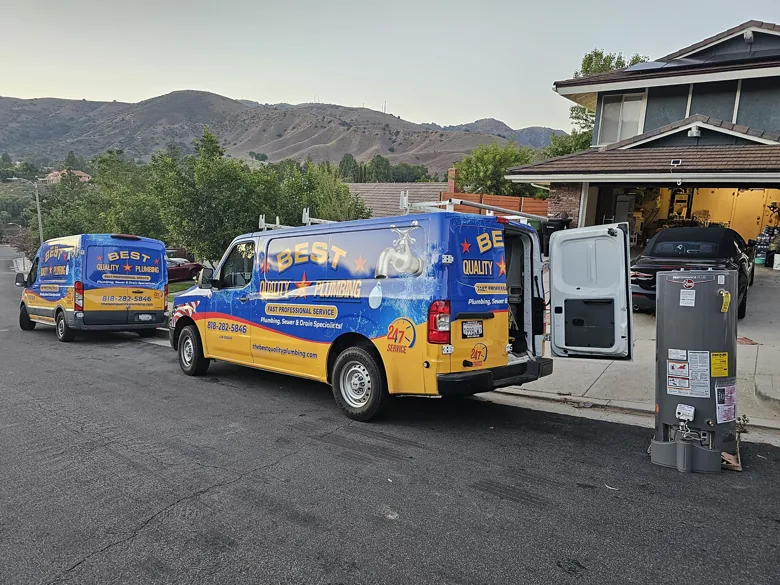 Company vans and boxed tank heater outside garage